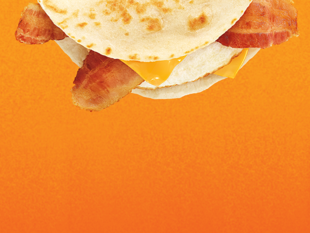 A bacon,egg and cheese wake-up wrap sandwich and A sausage egg and cheese sandwich on a croissant